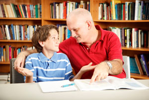 Child being helped to read by father