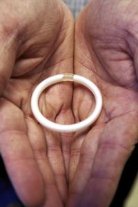 The ring being held in a pair of hands