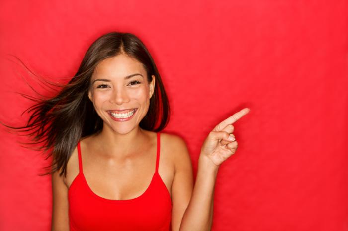 Smiling woman wearing red.