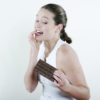A woman tempted to eat chocolate.